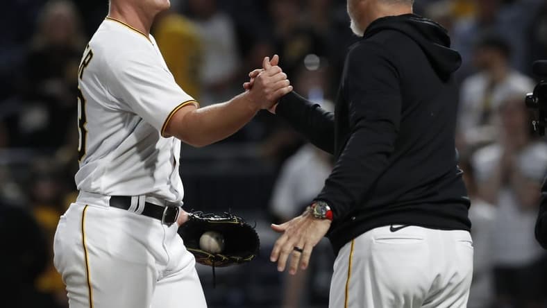 May 8, 2023; Pittsburgh, Pennsylvania, USA; Pittsburgh Pirates starting pitcher Mitch Keller (23) is congratulated by manager Derek Shelton (right) after Keller pitched a complete game four hit shutout against the Colorado Rockies at PNC Park. The Pirates shutout the Rockies 2-0. Mandatory Credit: Charles LeClaire-USA TODAY Sports