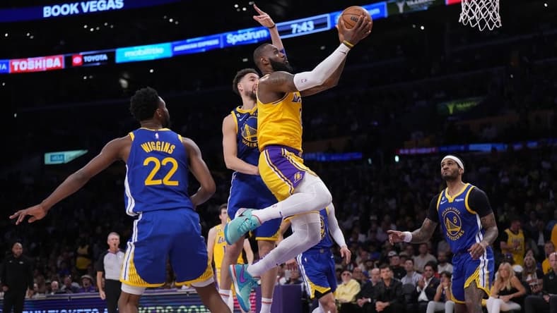 May 8, 2023; Los Angeles, California, USA; Los Angeles Lakers forward LeBron James (6) shoots the ball against Golden State Warriors forward Andrew Wiggins (22) and guard Klay Thompson (11) during game four of the 2023 NBA playoffs at Crypto.com Arena. Mandatory Credit: Kirby Lee-USA TODAY Sports