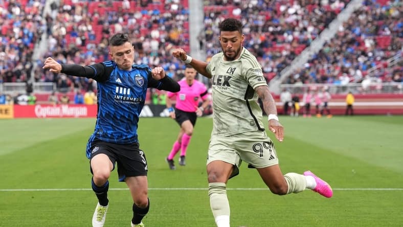 May 6, 2023; Santa Clara, California, USA; Los Angeles FC forward Denis Bouanga (99) shoots against San Jose Earthquakes defender Paul Marie (3) during the second half at Levi's Stadium. Mandatory Credit: Darren Yamashita-USA TODAY Sports