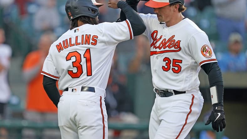 May 9, 2023; Baltimore, Maryland, USA; Baltimore Orioles catcher Adley Rutschman (35) greeted by outfielder Cedric Mullins (31) who scored on his two run home run in the third inning against the Tampa Bay Rays at Oriole Park at Camden Yards. Mandatory Credit: Mitch Stringer-USA TODAY Sports