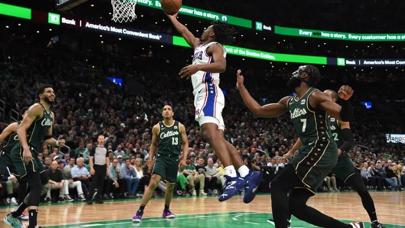 May 9, 2023; Boston, Massachusetts, USA; Philadelphia 76ers guard Tyrese Maxey (0) lays the ball in the basket past Boston Celtics guard Jaylen Brown (7) in the first half during game five of the 2023 NBA playoffs at TD Garden. Mandatory Credit: Bob DeChiara-USA TODAY Sports