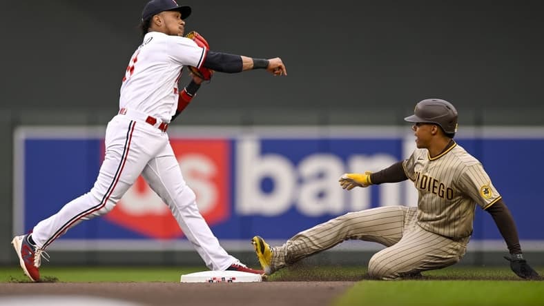 May 9, 2023; Minneapolis, Minnesota, USA; Minnesota Twins infielder Jorge Polanco (11) throws over San Diego Padres outfielder Juan Soto (22) to complete a double play during the second inning at Target Field. Mandatory Credit: Nick Wosika-USA TODAY Sports