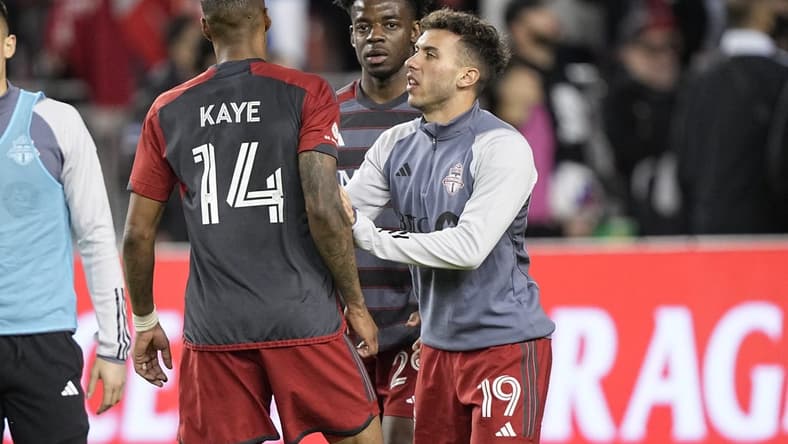May 9, 2023; Toronto, Ontario, CAN; Toronto FC forward Deandre Kerr (29) and defender Kobe Franklin (19) restrain midfielder Mark-Anthony Kaye (14) after an exchange with a fan following a loss to CF Montreal at BMO Field. Mandatory Credit: John E. Sokolowski-USA TODAY Sports