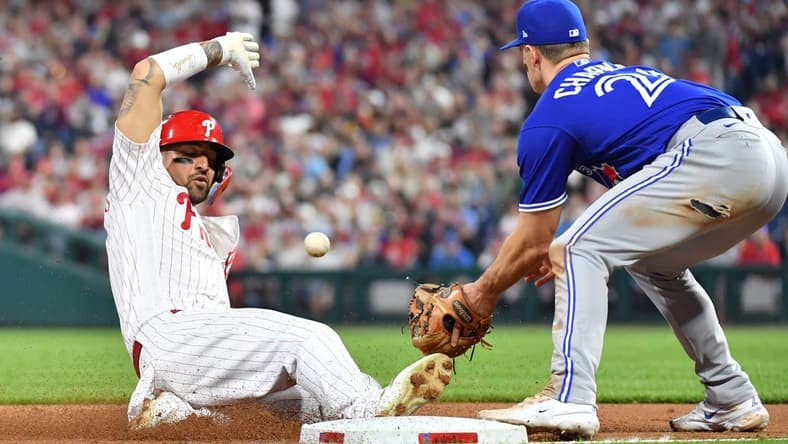May 9, 2023; Philadelphia, Pennsylvania, USA; Philadelphia Phillies right fielder Nick Castellanos (8) sides safely into third base ahead of tag by Toronto Blue Jays third baseman Matt Chapman (26) during the sixth inning at Citizens Bank Park. Mandatory Credit: Eric Hartline-USA TODAY Sports