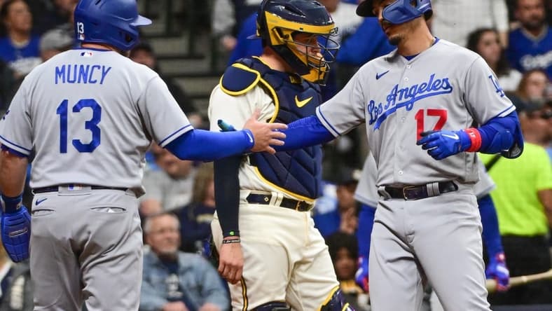 May 9, 2023; Milwaukee, Wisconsin, USA; Los Angeles Dodgers second baseman Miguel Vargas (17) celebrates with third baseman Max Muncy (13) after hitting a two run home run as Milwaukee Brewers catcher Victor Caratini (7) looks on in the sixth inning at American Family Field. Mandatory Credit: Benny Sieu-USA TODAY Sports