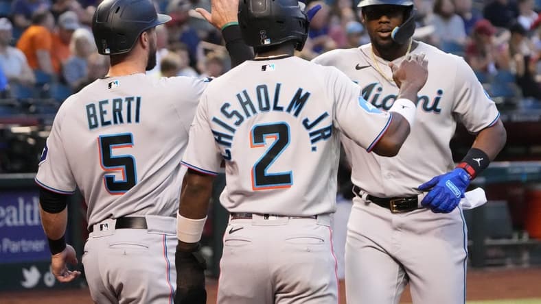 May 9, 2023; Phoenix, Arizona, USA; Miami Marlins designated hitter Jorge Soler (12) slaps hands with Miami Marlins shortstop Jon Berti (5) and Miami Marlins center fielder Jazz Chisholm Jr. (2) after hitting a three run home run against the Arizona Diamondbacks during the first inning at Chase Field. Mandatory Credit: Joe Camporeale-USA TODAY Sports