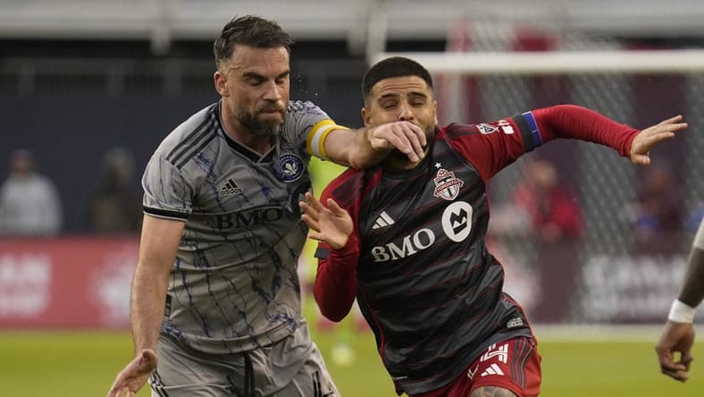 May 9, 2023; Toronto, Ontario, CAN; CF Montreal defender Rudy Camacho (4) and Toronto FC forward Lorenzo Insigne (24) battle for position during the first half at BMO Field. Mandatory Credit: John E. Sokolowski-USA TODAY Sports