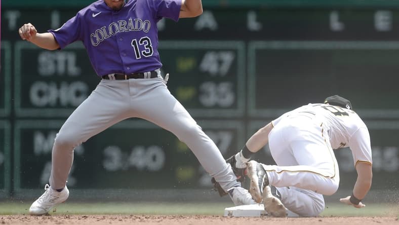 May 10, 2023; Pittsburgh, Pennsylvania, USA; Colorado Rockies second baseman Alan Trejo (13) is safe after stealing second base as Pittsburgh Pirates shortstop Chris Owings (right) attempts a tag during the fourth inning at PNC Park. Mandatory Credit: Charles LeClaire-USA TODAY Sports