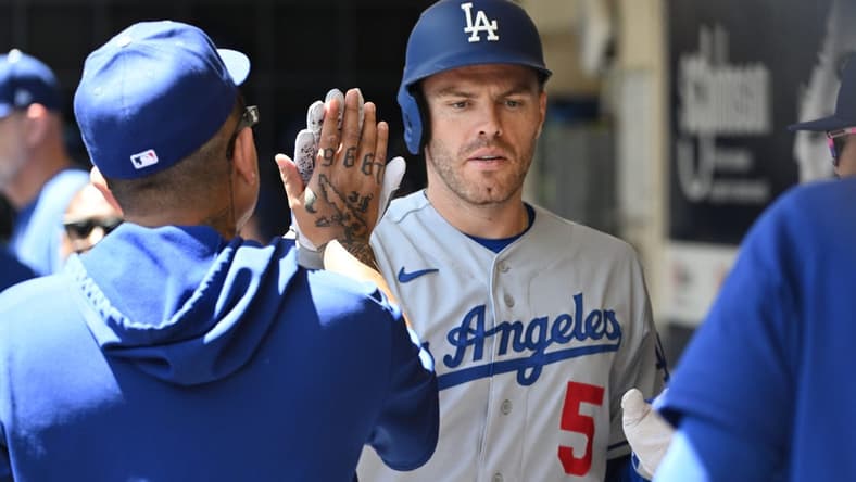 May 10, 2023; Milwaukee, Wisconsin, USA; Los Angeles Dodgers first baseman Freddie Freeman (5) is congratulated in the dug out after hitting a home run against the Milwaukee Brewers in the fourth inning at American Family Field. Mandatory Credit: Michael McLoone-USA TODAY Sports
