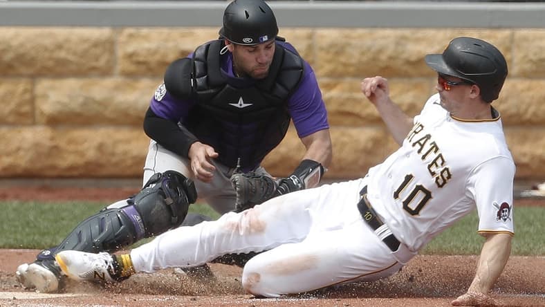 May 10, 2023; Pittsburgh, Pennsylvania, USA;  Colorado Rockies catcher Austin Wynns (16) tags Pittsburgh Pirates left fielder Bryan Reynolds (10) out at home plate attempting to score during the sixth inning at PNC Park. Mandatory Credit: Charles LeClaire-USA TODAY Sports