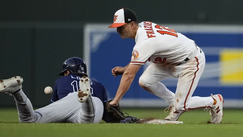 May 10, 2023; Baltimore, Maryland, USA; Tampa Bay Rays right fielder Josh Lowe (15) is safe at second base on a pickoff attempt by Baltimore Orioles second baseman Adam Frazier (12) in the fifth inning at Oriole Park at Camden Yards. Mandatory Credit: Brent Skeen-USA TODAY Sports