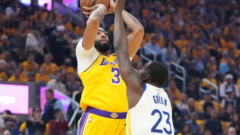 May 10, 2023; San Francisco, California, USA; Los Angeles Lakers forward Anthony Davis (3) shoots the basketball against Golden State Warriors forward Draymond Green (23) during the first quarter in game five of the 2023 NBA playoffs conference semifinals round at Chase Center. Mandatory Credit: Kyle Terada-USA TODAY Sports