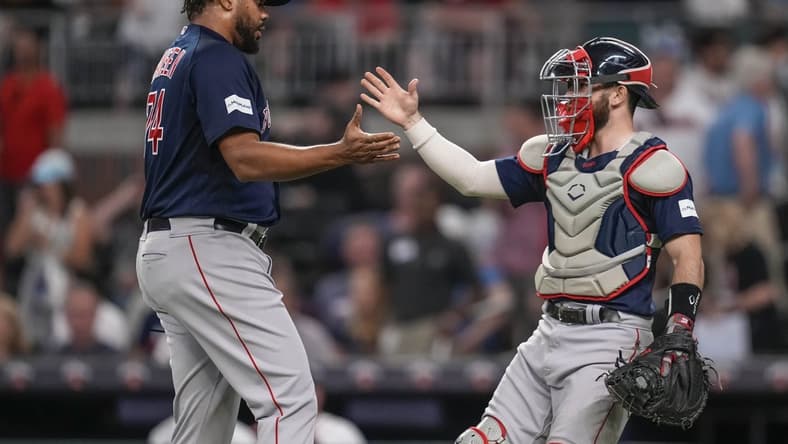 May 10, 2023; Cumberland, Georgia, USA; Boston Red Sox relief pitcher Kenley Jansen (74) reacts with catcher Connor Wong (12) after recording his 400th career save against the Atlanta Braves at Truist Park. Mandatory Credit: Dale Zanine-USA TODAY Sports