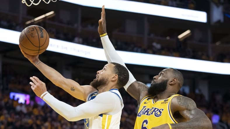 May 10, 2023; San Francisco, California, USA; Golden State Warriors guard Stephen Curry (30) shoots the basketball against Los Angeles Lakers forward LeBron James (6) during the third quarter in game five of the 2023 NBA playoffs conference semifinals round at Chase Center. Mandatory Credit: Kyle Terada-USA TODAY Sports