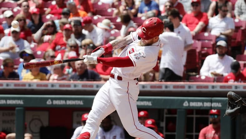 May 11, 2023; Cincinnati, Ohio, USA; Cincinnati Reds left fielder Jake Fraley (27) hits an RBI single against the New York Mets during the first inning at Great American Ball Park. Mandatory Credit: David Kohl-USA TODAY Sports