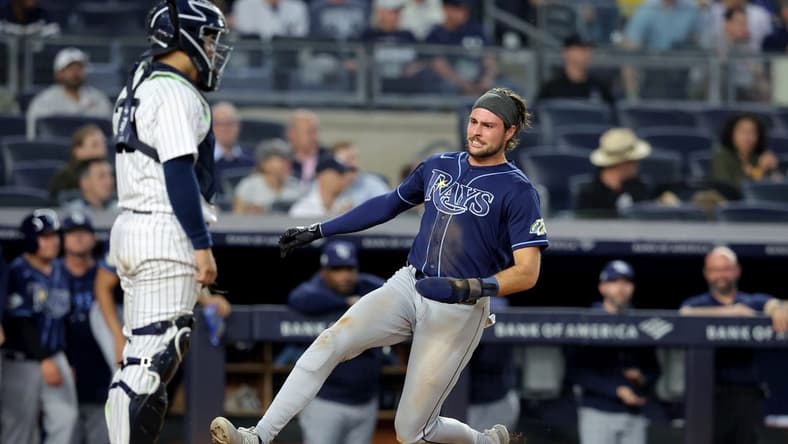 May 11, 2023; Bronx, New York, USA; Tampa Bay Rays right fielder Josh Lowe (15) scores a run against New York Yankees catcher Jose Trevino (39) on a double by first baseman Yandy Diaz (not pictured) during the fifth inning at Yankee Stadium. Mandatory Credit: Brad Penner-USA TODAY Sports