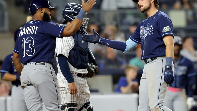 May 11, 2023; Bronx, New York, USA; Tampa Bay Rays right fielder Josh Lowe (15) celebrates his two run home run against the New York Yankees with center fielder Manuel Margot (13) during the eighth inning at Yankee Stadium. Mandatory Credit: Brad Penner-USA TODAY Sports