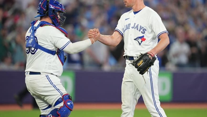 May 12, 2023; Toronto, Ontario, CAN; Toronto Blue Jays starting pitcher Chris Bassitt (40) celebrates a complete game win with Toronto Blue Jays catcher Alejandro Kirk (30) against the Atlanta Braves at the end of the the ninth inning at Rogers Centre. Mandatory Credit: Nick Turchiaro-USA TODAY Sports