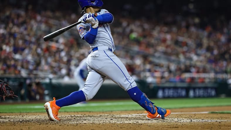May 12, 2023; Washington, District of Columbia, USA; New York Mets shortstop Francisco Lindor (12) hits a three run single against the Washington Nationals during the sixth inning at Nationals Park. Mandatory Credit: Scott Taetsch-USA TODAY Sports