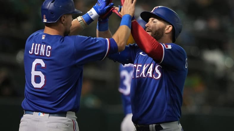 May 12, 2023; Oakland, California, USA; Texas Rangers right fielder Robbie Grossman (right) celebrates with third baseman Josh Jung (6) after hitting a home run against the Oakland Athletics during the sixth inning at Oakland-Alameda County Coliseum. Mandatory Credit: Darren Yamashita-USA TODAY Sports