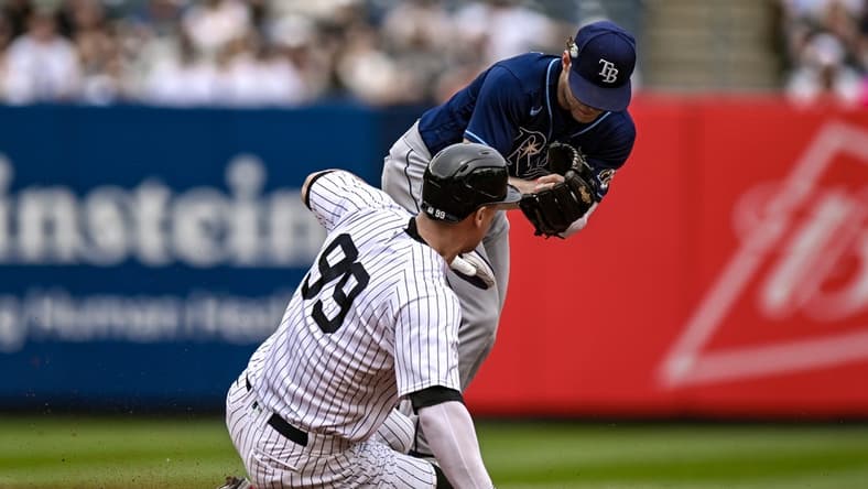 May 13, 2023; Bronx, New York, USA; Tampa Bay Rays second baseman Taylor Walls (6) forces out New York Yankees center fielder Aaron Judge (99) at second base at Yankee Stadium. Mandatory Credit: John Jones-USA TODAY Sports