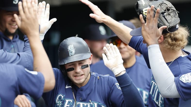 May 13, 2023; Detroit, Michigan, USA; Seattle Mariners left fielder Jarred Kelenic (10) is congratulated by teammates after hitting a two-run home run in the third inning against the Detroit Tigers at Comerica Park. Mandatory Credit: Rick Osentoski-USA TODAY Sports