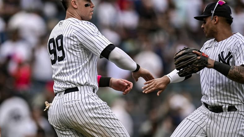 May 13, 2023; Bronx, New York, USA; New York Yankees center fielder Aaron Judge (99) celebrates with teammates after defeating the Tampa Bay Rays 9-8 at Yankee Stadium. Mandatory Credit: John Jones-USA TODAY Sports