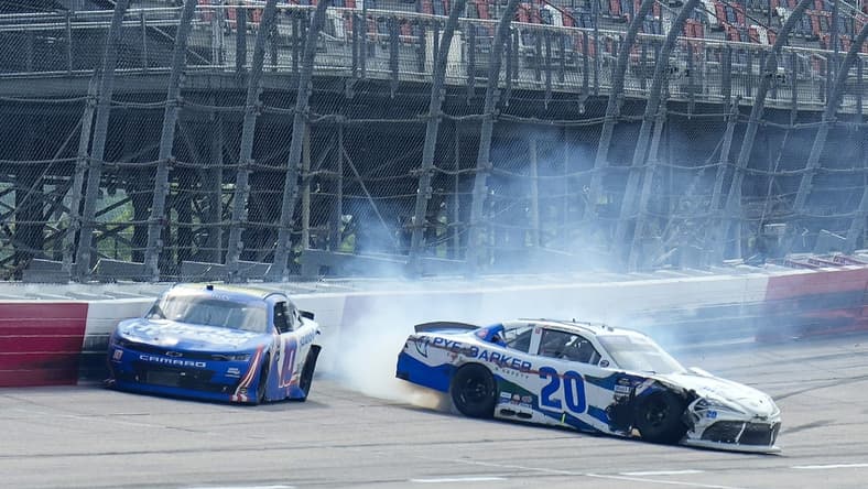 May 13, 2023; Darlington, South Carolina, USA; NASCAR Xfinity Series driver John Hunter Nemechek (20) wrecks as  Kyle Larson (10) drives to the checkered flag during the Xfinity Series Shriners Children   s 200 at Darlington Raceway. Mandatory Credit: David Yeazell-USA TODAY Sports