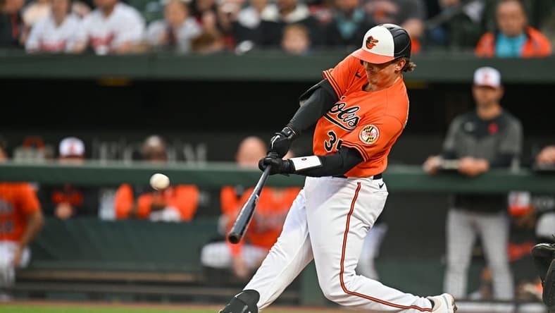 May 13, 2023; Baltimore, Maryland, USA; Baltimore Orioles catcher Adley Rutschman (35) hits a home run in the first inning against the Pittsburgh Pirates at Oriole Park at Camden Yards. Mandatory Credit: Reggie Hildred-USA TODAY Sports
