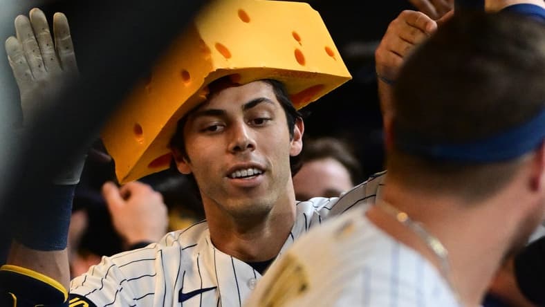 May 13, 2023; Milwaukee, Wisconsin, USA; Milwaukee Brewers left fielder Christian Yelich (22) celebrates in the dugout after hitting a 2-run home run in the third inning against the Kansas City Royals at American Family Field. Mandatory Credit: Benny Sieu-USA TODAY Sports