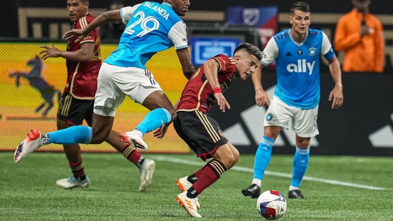 May 13, 2023; Atlanta, Georgia, USA; Atlanta United midfielder Thiago Almada (23) controls the ball in front of Charlotte FC defender Adilson Malanda (29) during the first half at Mercedes-Benz Stadium. Mandatory Credit: Dale Zanine-USA TODAY Sports