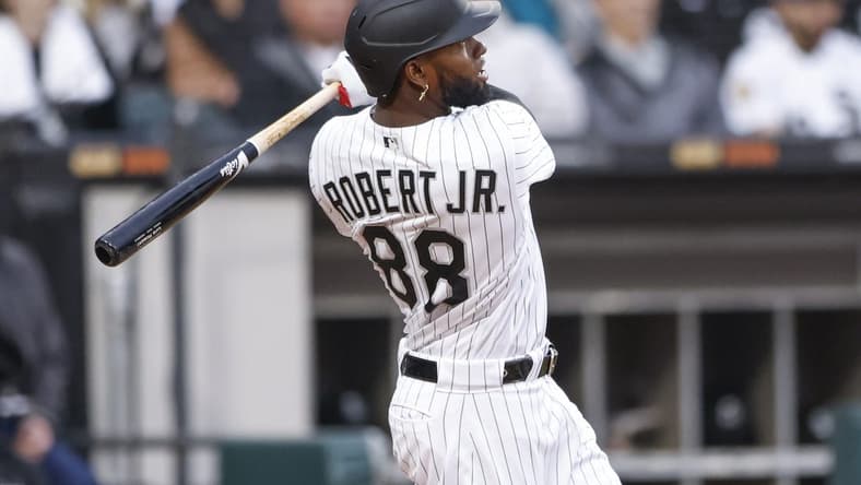 May 13, 2023; Chicago, Illinois, USA; Chicago White Sox center fielder Luis Robert Jr. (88) hits a solo home run against the Houston Astros during the fourth inning at Guaranteed Rate Field. Mandatory Credit: Kamil Krzaczynski-USA TODAY Sports
