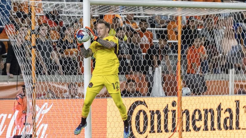 May 13, 2023; Houston, Texas, USA; Houston Dynamo goalkeeper Steve Clark (12) makes a save against the Seattle Sounders in the first half at Shell Energy Stadium. Mandatory Credit: Thomas Shea-USA TODAY Sports