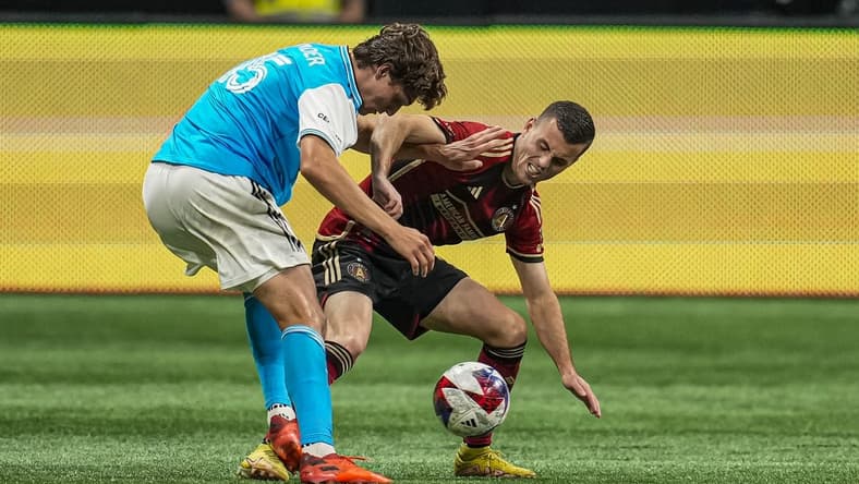 May 13, 2023; Atlanta, Georgia, USA; Charlotte FC defender midfielder Benjamin Bender (15)  and Atlanta United defender Brooks Lennon (11) fight for the ball at Mercedes-Benz Stadium. Mandatory Credit: Dale Zanine-USA TODAY Sports