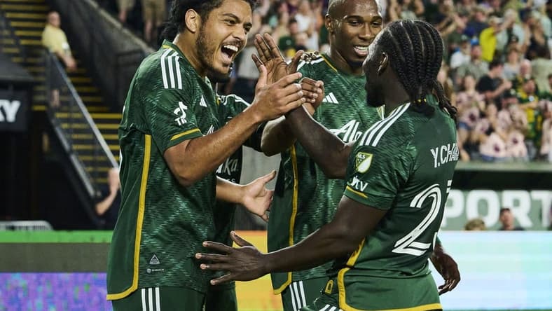 May 13, 2023; Portland, Oregon, USA; Portland Timbers midfielder Evander (20) celebrates with teammates after scoring a goal in the second half against the Vancouver Whitecaps at Providence Park. Mandatory Credit: Troy Wayrynen-USA TODAY Sports