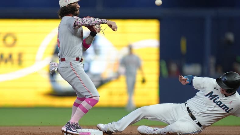 May 14, 2023; Miami, Florida, USA; Cincinnati Reds second baseman Jonathan India (6) attempts to complete a double play after getting the force out at second base of Miami Marlins first baseman Garrett Cooper (26) in the first inning at loanDepot Park. Mandatory Credit: Jim Rassol-USA TODAY Sports