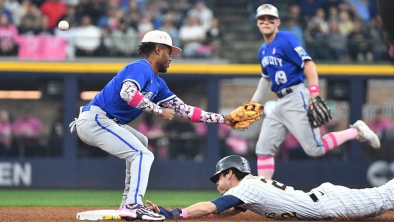 May 14, 2023; Milwaukee, Wisconsin, USA; Milwaukee Brewers left fielder Christian Yelich (22) slides in safely into second base as Kansas City Royals shortstop Maikel Garcia (11) can t doesn t make the play at American Family Field. Mandatory Credit: Michael McLoone-USA TODAY Sports