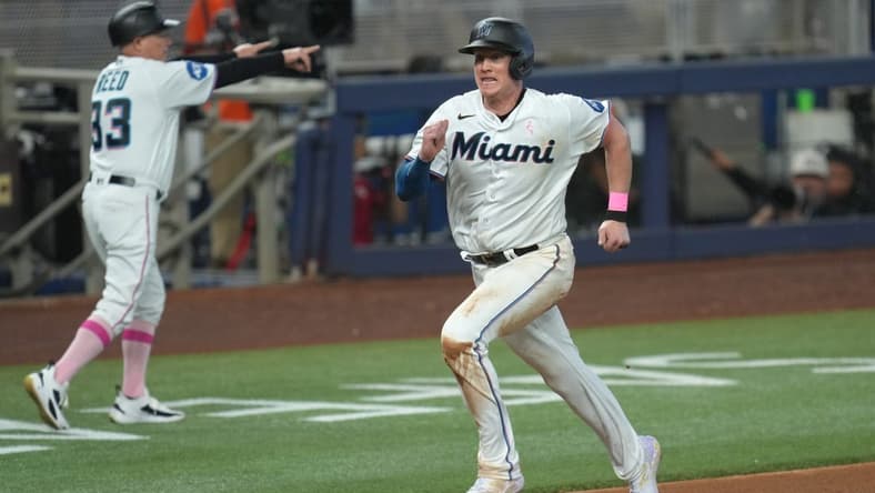 May 14, 2023; Miami, Florida, USA; Miami Marlins first baseman Garrett Cooper (26) scores a run in the seventh inning against the Cincinnati Reds at loanDepot Park. Mandatory Credit: Jim Rassol-USA TODAY Sports