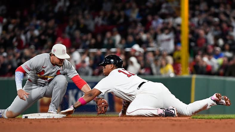 May 14, 2023; Boston, Massachusetts, USA; Boston Red Sox third baseman Rafael Devers (11) is tagged out at second base by St. Louis Cardinals second baseman Nolan Gorman (16) during the fourth inning at Fenway Park. Mandatory Credit: Eric Canha-USA TODAY Sports