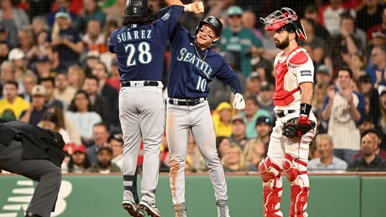 May 15, 2023; Boston, Massachusetts, USA; Seattle Mariners third baseman Eugenio Suarez (28) celebrates with left fielder Jarred Kelenic (10) after hitting a two-run home run against the Boston Red Sox during the eighth inning at Fenway Park. Mandatory Credit: Brian Fluharty-USA TODAY Sports