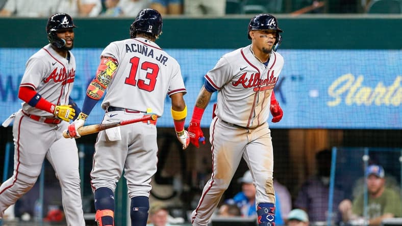 May 15, 2023; Arlington, Texas, USA; Atlanta Braves shortstop Orlando Arcia (11) is congratulated by right fielder Ronald Acuna Jr. (13) after he hits a two-run home run against the Texas Rangers during the sixth inning at Globe Life Field. Mandatory Credit: Andrew Dieb-USA TODAY Sports