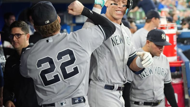 May 15, 2023; Toronto, Ontario, CAN; New York Yankees right fielder Aaron Judge (99) celebrates in the dugout with center fielder Harrison Bader (22) after hitting a home run against the Toronto Blue Jays during the eighth inning at Rogers Centre. Mandatory Credit: Nick Turchiaro-USA TODAY Sports