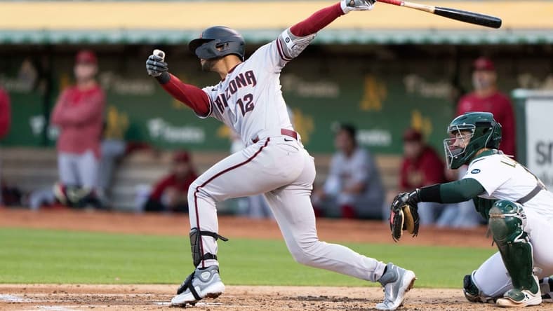 May 15, 2023; Oakland, California, USA; Arizona Diamondbacks left fielder Lourdes Gurriel Jr. (12) hits a two-run home run during the third inning against the Oakland Athletics at Oakland-Alameda County Coliseum. Mandatory Credit: Stan Szeto-USA TODAY Sports
