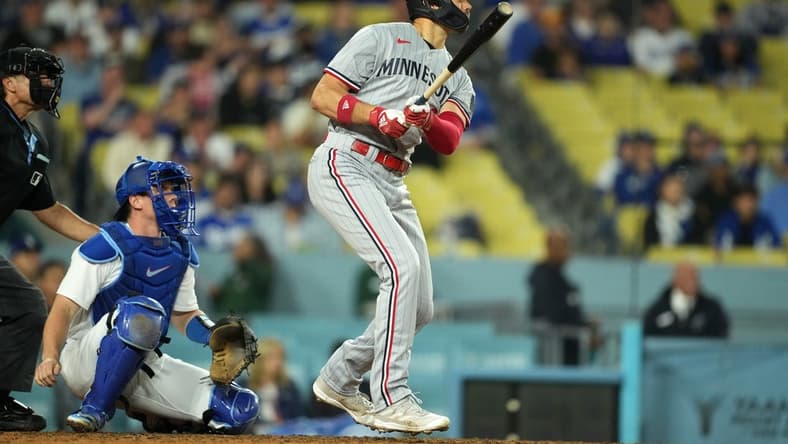 May 15, 2023; Los Angeles, California, USA; Minnesota Twins right fielder Trevor Larnach (9) follows through on a three-run home run in the eighth inning as Los Angeles Dodgers catcher Will Smith (16) reacts at Dodger Stadium. Mandatory Credit: Kirby Lee-USA TODAY Sports