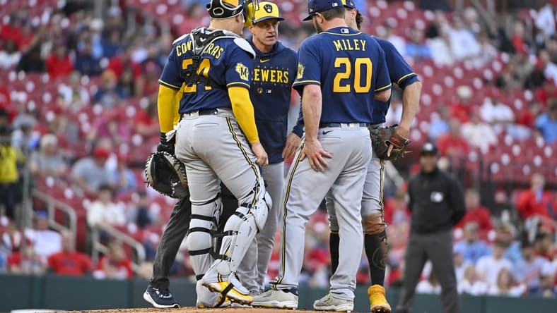 May 16, 2023; St. Louis, Missouri, USA; Milwaukee Brewers manager Craig Counsell (30) talks with starting pitcher Wade Miley (20) during the second inning against the St. Louis Cardinals at Busch Stadium. Mandatory Credit: Jeff Curry-USA TODAY Sports