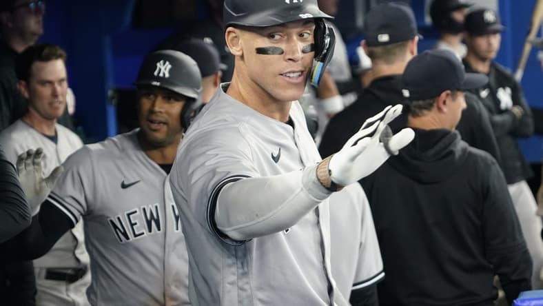 May 16, 2023; Toronto, Ontario, CAN; New York Yankees designated hitter Aaron Judge (99) celebrates in the dugout after hitting a two run home run against the Toronto Blue Jays during the eighth inning at Rogers Centre. Mandatory Credit: John E. Sokolowski-USA TODAY Sports
