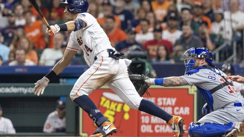 May 16, 2023; Houston, Texas, USA; Houston Astros second baseman Mauricio Dubon (14) hits a double against the Chicago Cubs in the seventh inning at Minute Maid Park. Mandatory Credit: Thomas Shea-USA TODAY Sports