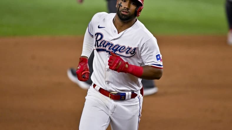 May 16, 2023; Arlington, Texas, USA; Texas Rangers shortstop Ezequiel Duran (20) rounds the bases after he hits a home run against the Atlanta Braves during the eighth inning at Globe Life Field. Mandatory Credit: Jerome Miron-USA TODAY Sports