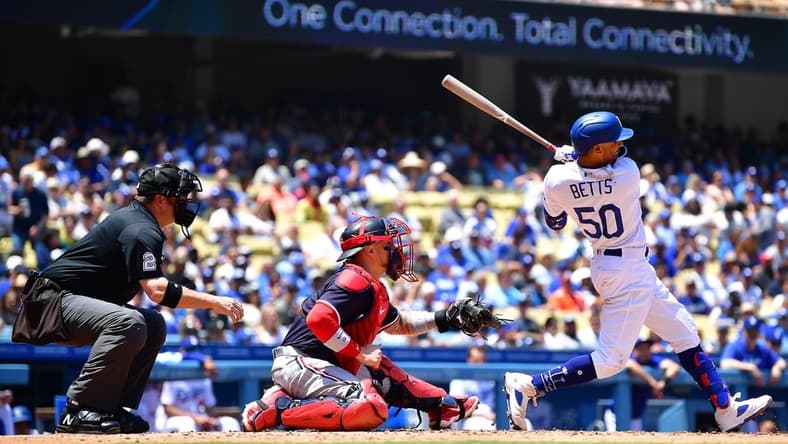 May 17, 2023; Los Angeles, California, USA; Los Angeles Dodgers right fielder Mookie Betts (50) hits an RBI single against the Minnesota Twins during the fourth inning at Dodger Stadium. Mandatory Credit: Gary A. Vasquez-USA TODAY Sports