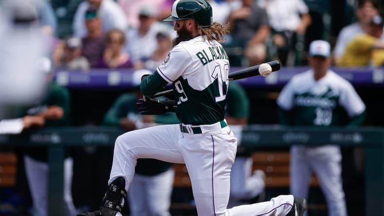 May 17, 2023; Denver, Colorado, USA; Colorado Rockies designated hitter Charlie Blackmon (19) drops to the ground after a foul tip in the fifth inning against the Cincinnati Reds at Coors Field. Mandatory Credit: Isaiah J. Downing-USA TODAY Sports